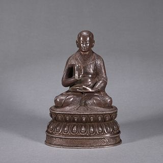 A silver Tibetan buddha statue