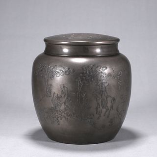 An inscribed figure patterned tin jar