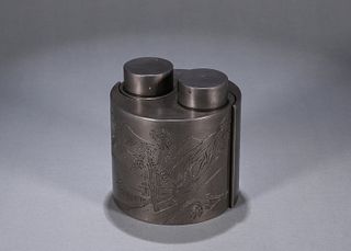 An inscribed landscape patterned tin jar