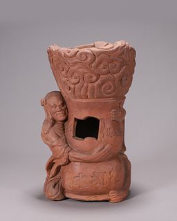 A red clay figure with censer