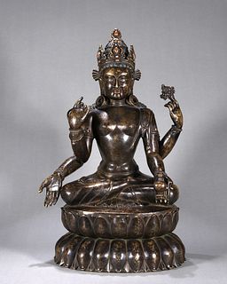 A copper silver-inlaid four-armed Guanyin bodhisattva statue