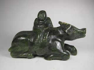 A CHINESE CARVED  DARK-GREEEN JADE BOY ON A BULL