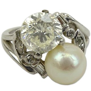 Lady's Retro Approx. 1.0 Carat Round Brilliant Cut Diamond and Pearl Cross Over Ring Set in Platinum.
