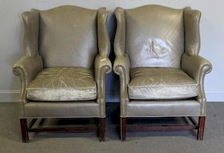 Pair of Leather Upholstered Wing Arm Chairs.