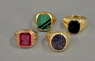 Four 14K gold men's rings with stones, 25.6 grams.
