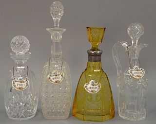 Four cut glass and etched crystal decanters with stoppers, ht. 10" to 14 1/2".