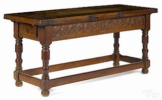 European walnut refectory table, 17th c., with extension leaves and a carved apron