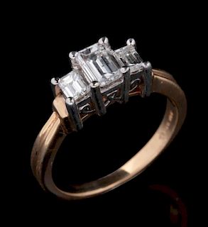 A 14K ENGAGEMENT RING WITH THREE EMERALD CUT DIAMONDS