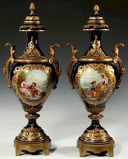A PAIR OF SEVRES TYPE PORCELAIN URNS WITH ORMOLU MOUNTS
