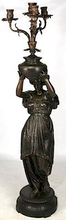 A 67-INCH PATINATED SPELTER FIGURAL LADY CANDELABRUM