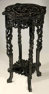 A HIGHLY CARVED CHINESE STAND TABLE WITH SHELL INLAY