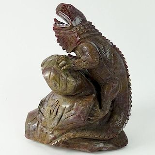 Carved Rhodonite Iguana Figure. With forked tongue perched on a limb.