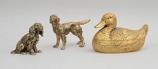 GUCCI GILT-METAL DUCK-FORM TUREEN AND COVER, A GUCCI GILT-METAL SETTER AND A GUCCI GILT-METAL FIGURE OF A SEATED SPANIEL