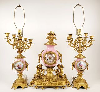 19th C. Sevres Porcelain & Gilt Bronze Figural Clockset. The clock measures H: 21" W: 16 1/4" and the candelabras measure H: 31 1/2" W: 9 1/2"