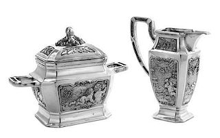 A German Silver Creamer and Sugar, Maker's Mark Obscured, Late 19th/Early 20th Century, each having a paneled body decorated wit