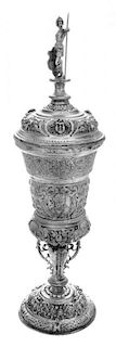 A German Silver Pokal, Hanau, Late 19th Century, surmounted by an armored warrior and worked throughout with repousse masks and