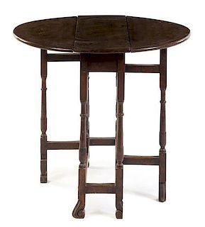 An English Oak Gate-Leg Table Height 28 1/4 x width 10 1/4 x depth 27 inches.