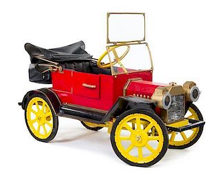 An American Pressed Metal Pedal Car Height 23 x length 40 inches.