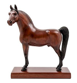 * A Carved and Painted Wood Figure of a Thoroughbred Horse Height 13 inches.