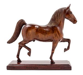 * A Carved Wood Figure of a Thoroughbred Horse Height 12 1/4 inches.