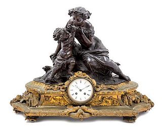 * A Napoleon III Gilt and Patinated Bronze Figural Mantel Clock Width 25 inches.