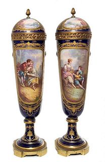 * A Pair of Sevres Porcelain Lidded Urns Height 28 inches.