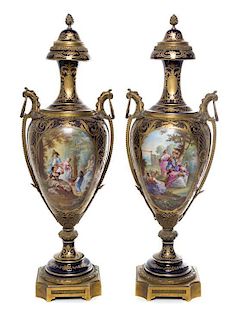 * A Pair of Sevres Gilt Bronze Mounted Porcelain Urns Height 29 inches.