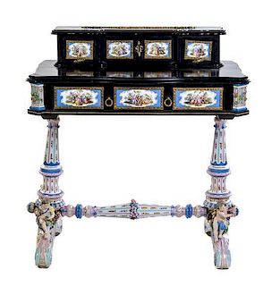 A German Gilt Metal and Porcelain Mounted Ebonized Writing Table Height 36 3/4 x width 34 x depth 20 inches.