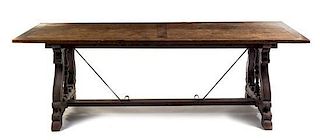 A Spanish Baroque Walnut and Iron Trestle Table Height 29 1/2 x width 35 1/2 x depth 94 3/4 inches.