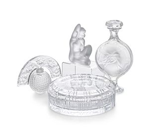 A group of glass vanity items