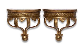 A pair of Continental carved giltwood wall shelves