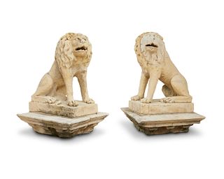 A pair of cast stone lion garnitures