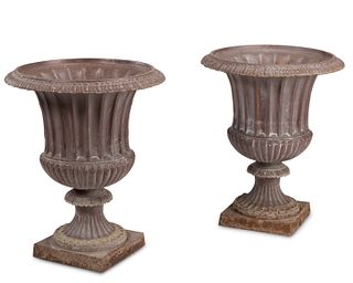 A near-pair of cast iron outdoor garden urns