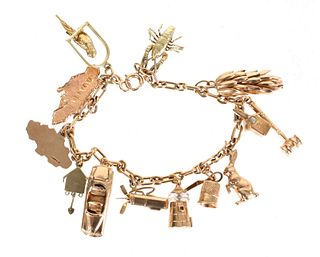 A 14k Gold Charm Bracelet with 13 Charms