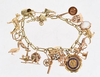 A 14k Gold Charm Bracelet with 17 Charms