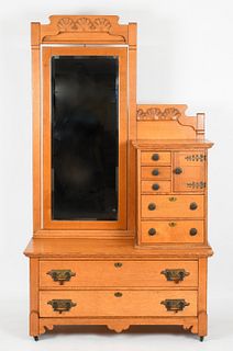 An Art Nouveau carved oak dressing chest and mirror