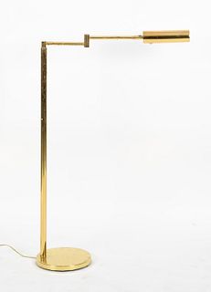 A brass adjustable reading floor lamp