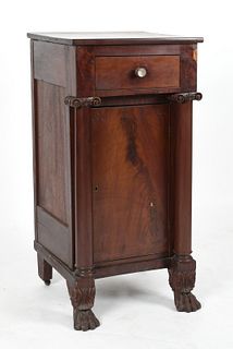 An American Classical carved mahogany cabinet