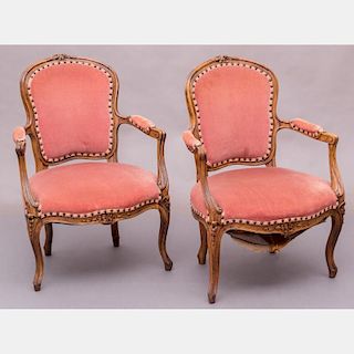 A Pair of French Provincial Style Carved Walnut and Velvet Upholstered Fauteuils, 19th/20th Century.