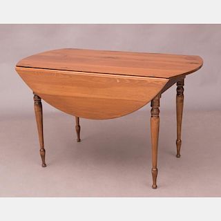 An American Pine Drop Leaf Table, 20th Century.