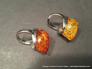 A pair of large Chinese Silver Amber rings.