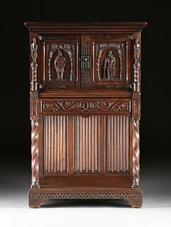 A BELGIAN NEO-GOTHIC CARVED OAK AND WALNUT CABINET ON STAND, EARLY 20TH CENTURY,  