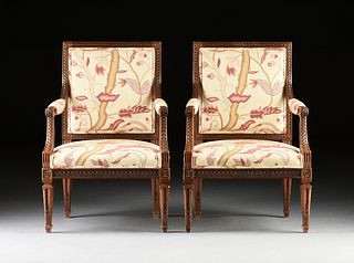 A PAIR OF LOUIS XVI STYLE CARVED AND UPHOLSTERED WALNUT FAUTEUILS, 20TH CENTURY,