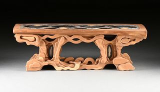 A PETRIFIED PALM INLAID AND CARVED CEDAR COFFEE TABLE / BENCH, 1970s,