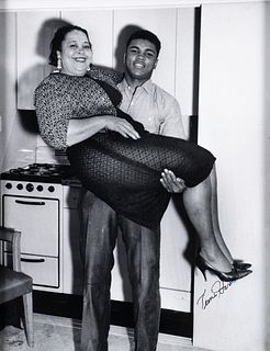 Teenie Harris photo Muhammad Ali lifting his mother