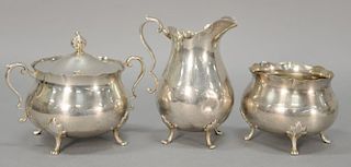 Three piece sterling silver group to include creamer, sugar, and covered sugar, 15.6 t oz.