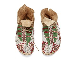 A pair of Plains Indian beaded hide moccasins