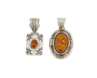 Two Southwest silver and amber pendants
