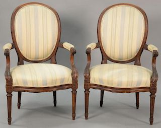 Pair of Louis XVI French style upholstered armchairs with oval backs.