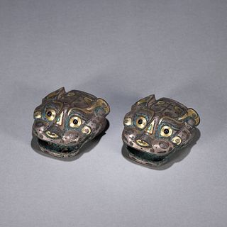 A pair of bronze beast paperweights